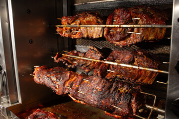A view of a rotisserie setup for pork spare ribs.