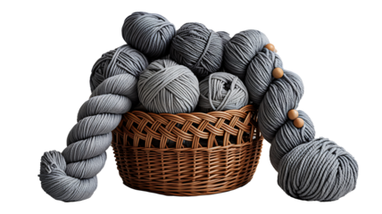 Grey yarn balls in woven basket on white background for knitting and craft concept  
