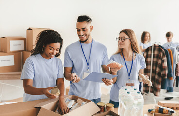 Volunteers gather at a community center, sorting food items and engaging in cheerful conversation. They work together to prepare packages for those in need while promoting a sense of unity.