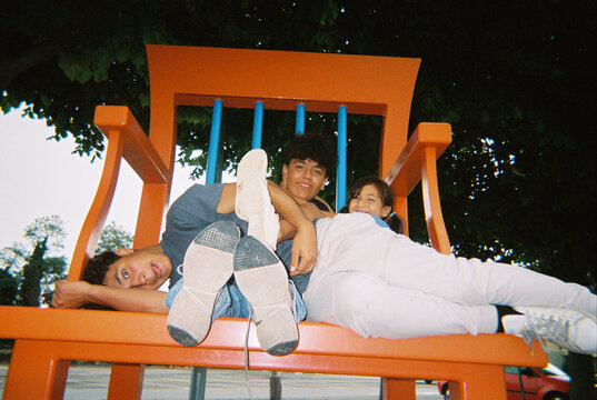 Friends Relaxing on a Large Chair 