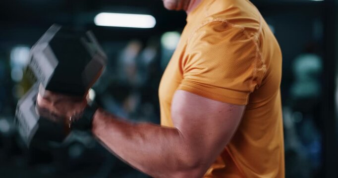 Arms, dumbbell and fitness with man in gym for strength training or workout routine. Bicep, exercise and weightlifting with bodybuilder in health club for physical challenge, power or resilience