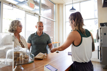 Couple purchasing at local bakery