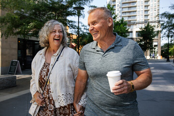 Happy couple laughing on a walk