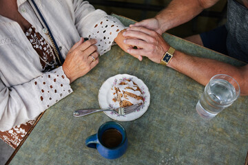 Tender moment shared over dessert focussing on hands