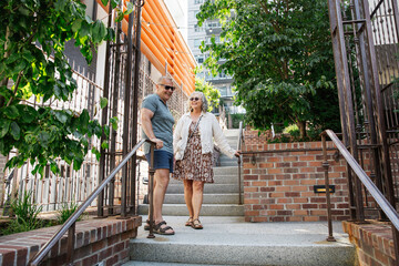 Smiling couple walking outdoor stairs