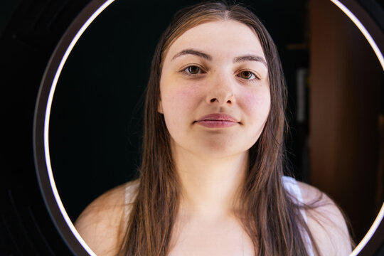 Portrait of a young individual under circular ring lighting