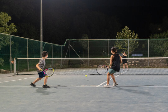 Evening Tennis Practice Session on Outdoor Courts