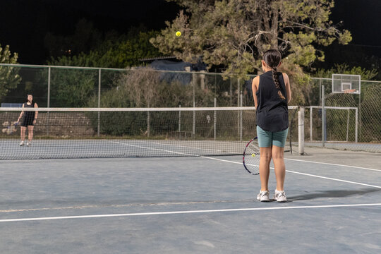 Night Tennis Match Between Two Players on Outdoor Court