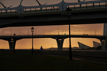 Sunset over modern bridges in a city