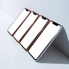Diagonal row of contemporary mobile phones with empty white screens for UI UX design presentation mockup on a minimalist light surface with hard shadows
