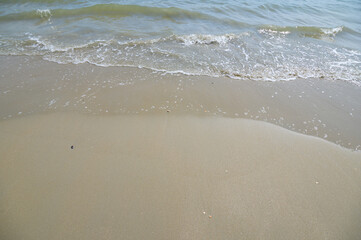 Serene Beach Scene in Rayong Province with Gentle Waves and Sand