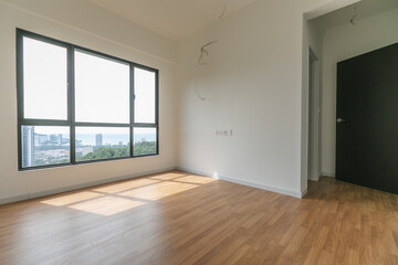 Empty Condominium Bedroom With Wooden Floor And City View