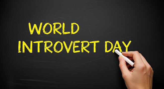 Hand writing World Introvert Day on a blackboard with chalk person - Powered by Adobe