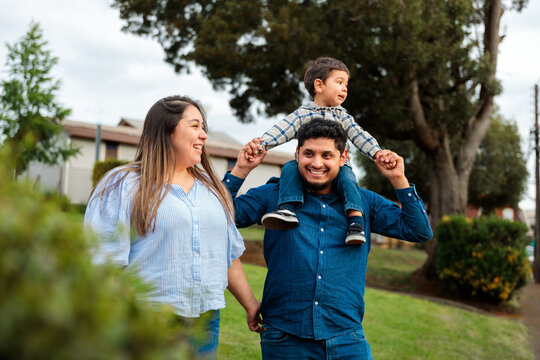 Family Walk with Child on Father&rsquo;s Shoulders