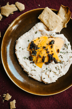 vegan savory dip with flatbreads on rustic table