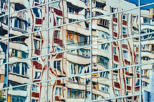 Reflection of buildings in modern glass facade