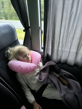 Child Sleeping Peacefully on a Bus Ride