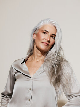 Elegant Older Woman With Silver Hair in a Stylish Blouse