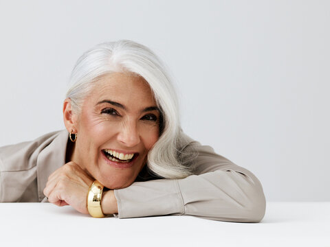 Joyful Senior Woman Smiling With Silver Hair and Elegant Jewelry