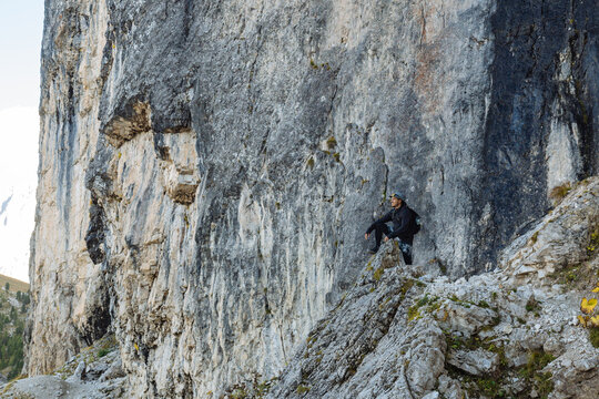 Climber Scaling a Rocky Mountain in the Dolomites During Daylight