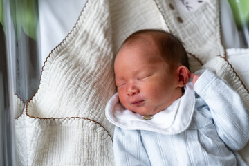 Sleeping newborn baby in a cozy, light-filled environment