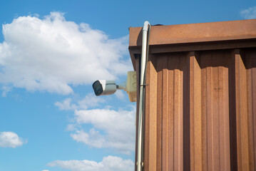 Surveillance Camera on Building Edge Sky