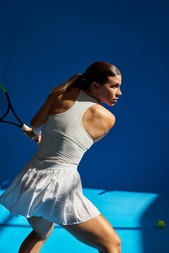 Tennis player preparing to serve on blue court background