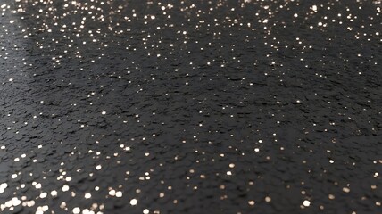 Abstract dark background with scattered shimmering silver and gold glitter particles creating a festive and luxurious texture