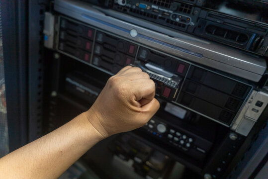 Hand Knocking on Server Rack Panel
