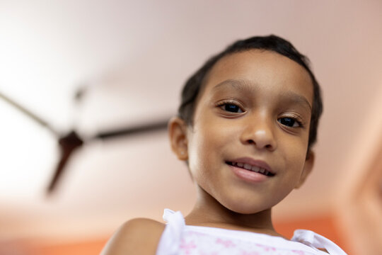Low angle portrait of a toddler looking at camera