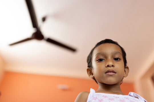 Low angle portrait of a toddler looking at camera