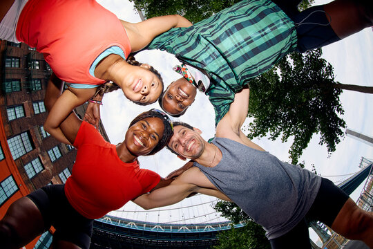 Group portrait of happy athletes from below