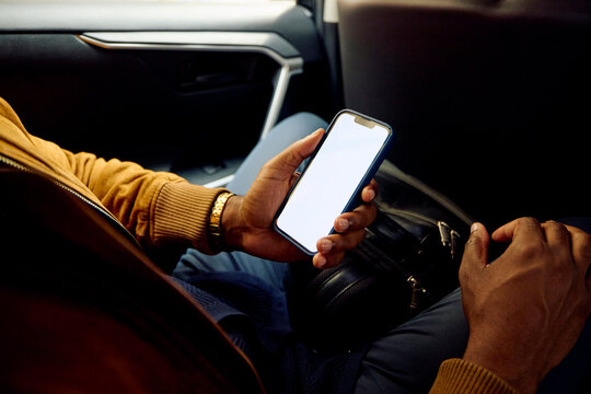 Passenger uses the phone in the car