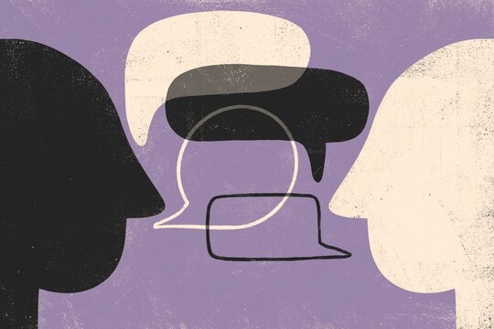 Two Heads with Speech Bubbles — Communication and Diversity Concept 