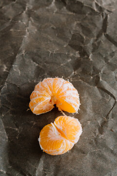 Halved mandarin orange on rustic paper