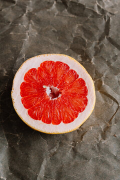 Slice of vibrant blood orange on paper