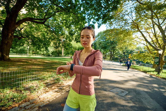 Sportswoman checks the pace on her watch