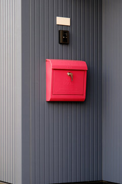 Red Mailbox on Gray Wall