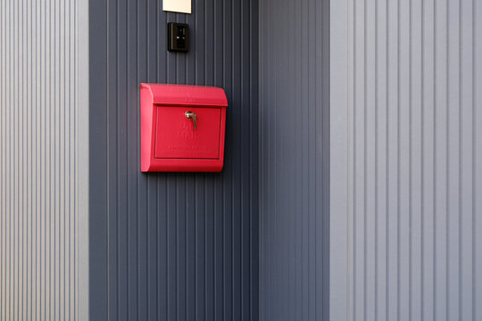 Red Mailbox on Textured Wall