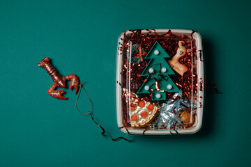 a festive square container with christmas ornaments and a red lobster