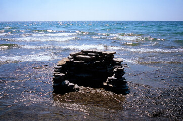 Slabs of rocks placed to form a curved barrier by the lake