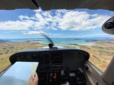 Light Aircraft Cockpit View With Pilot holding a Map. 