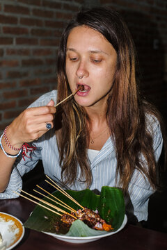 Enjoying Traditional Skewered Food in a Cozy Restaurant Setting