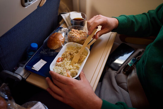 Passenger consumes food while flying