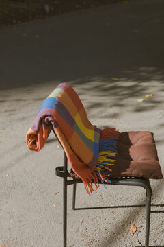 Colorful Blanket Draped Over Chair in a Quiet Outdoor Setting