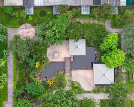 Community courtyard aerial view with pond and pavilions