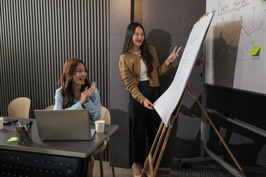 Business woman presenting new project during team meeting, busy people collaborate work in conference room setting, successful woman claps for colleague performance - Powered by Adobe