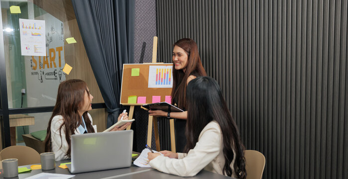 Business women meet, busy team people discuss project work, professional colleagues collaborate during meeting, analyzing charts, graphs for successful business development, planning future strategy