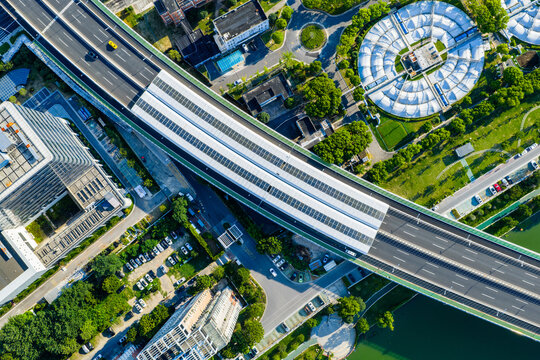 Aerial view of city overpass with solar panels and green surroundings