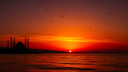 Majestic Istanbul Mosque Silhouette at Fiery Sunset Over Water